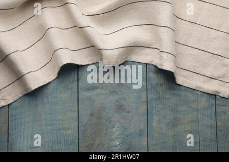 Kitchen towel on blue wooden background, top view. Space for text Stock Photo