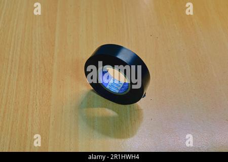 jakarta indonesia, 14 may 2023, rolls of black insulating tape on a wooden table Stock Photo