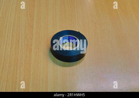 jakarta indonesia, 14 may 2023, rolls of black insulating tape on a wooden table Stock Photo