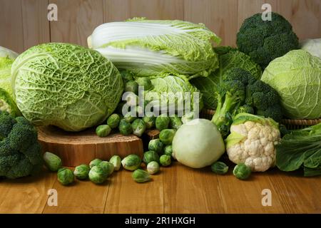 Many different types of fresh cabbage on wooden table Stock Photo