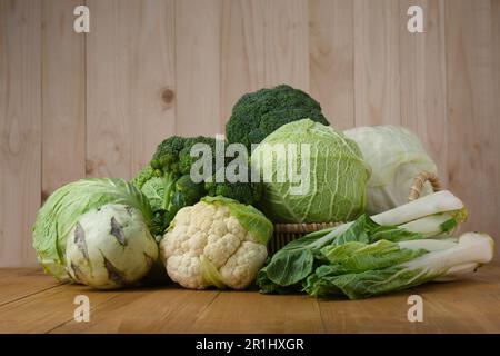 Many different types of fresh cabbage on wooden table Stock Photo