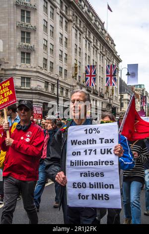 Activist Peter Tatchell carries the placard about Wealth Tax for the billionaires, May Day International Workers' Day rally, London, England, UK, 01/0 Stock Photo