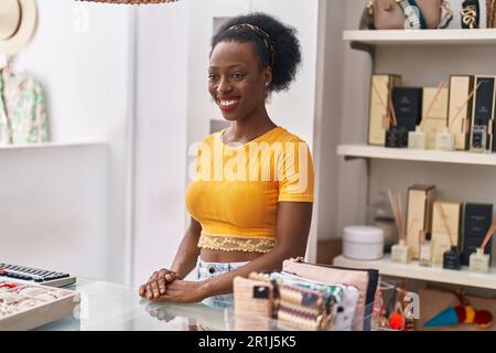 African american woman shop assistant using computer working at clothing store Stock Photo