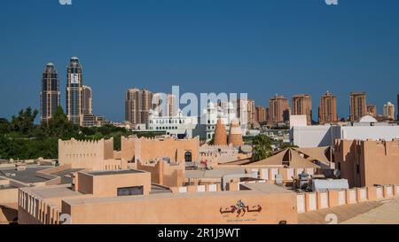 View from the amphitheater over the roofs of Katara Cultural Village and the highrises of Doha's Pearl Isalnd Stock Photo