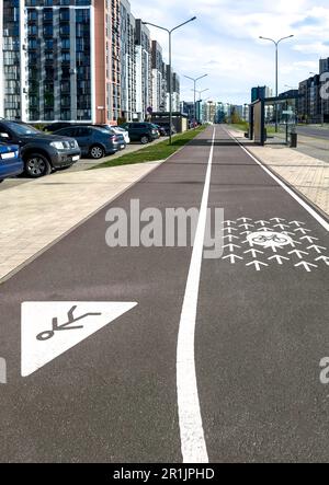 Road divided for bicycles and pedestrians in eco city, urban view. Stock Photo