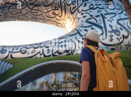 20 March 2023, Dubai, UAE: happy Tourist asian woman near Museum of The Future - New Attraction in Dubai downtown built for EXPO 2020 Stock Photo