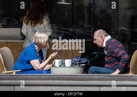 Elderly couple sitting by the window in a cafe in Helsinki, Finland Stock Photo