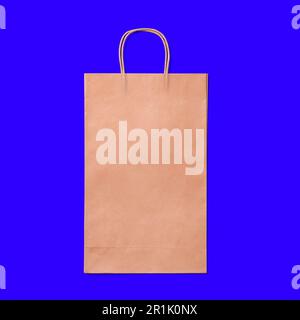 Luxury recycled paper shopping. bag isolated on blue background. Stock Photo