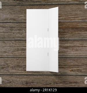 Blank white half fold paper over wooden background. Stock Photo