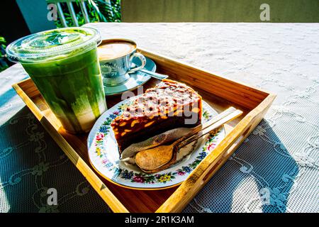 Flat lay of coffee latte matcha green tea and nut tart Stock Photo