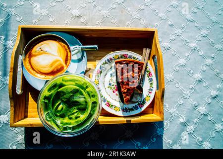 Flat lay of coffee latte matcha green tea and nut tart Stock Photo