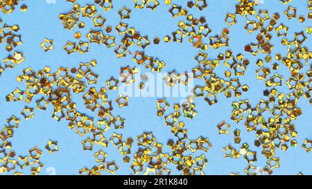 Beautiful star shaped sequins on light blue background, flat lay Stock Photo