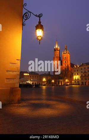 St Marys Basilica and a old street lamp before sunrise, Krakow, Poland, Europe. Stock Photo