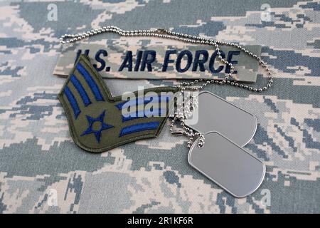 August 31, 2020. US AIR FORCE branch tape and Senior Airman rank patch and dog tags on digital tiger-stripe pattern Airman Battle Uniform (ABU) backgr Stock Photo