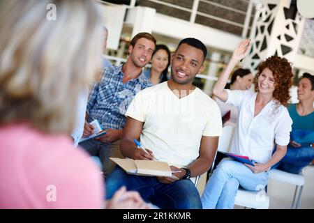 taking notes to remember it all. woman asking a question during a presentation at work. Stock Photo