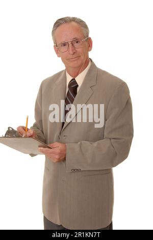 Senior businessman taking notes on a clipboard Stock Photo