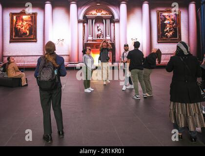 London, UK, 14th May 2023. Visitors view 'The Summer Palace', by Agustin Vidal Saavedra at the Outernet near Tottenham Court Road in London.The visual installation, a mix of renaissance paintings and artwork in an AI created palace,  is shown on huge, 360 degree, 8k resolution screens, and is free to see for the general public. It has so far been very popular with audiences and has been extended several times. Stock Photo