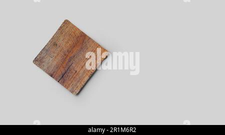 Empty square cork coaster, isolated on grey background. Perfect as food display. Stock Photo