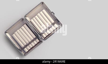 Fresh tobacco and handmade cigarettes on old metallic box. Stock Photo