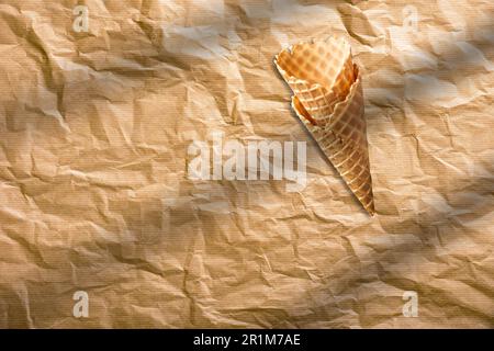 Empty crispy ice cream cone isolated on brown paper. food concept element. Stock Photo