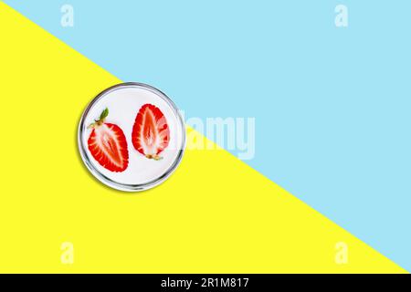 Two strawberry slices over milk flat lay concept isolated . Stock Photo