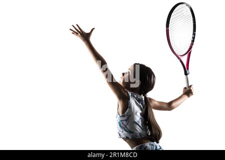 Young female tennis player silhouette. Little girl posing with racket and ball isolated on white background. Stock Photo