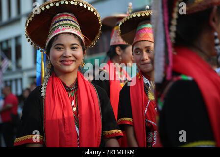Charming Bidayuh girl with her team in traditional dress, Kuching, Sarawak, Malaysia, Borneo. Stock Photo