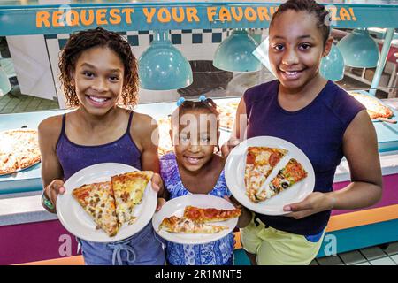 Sevierville Tennessee,Mr. Gatti's Buffet Style Pizza & Games,restarant interior inside,sliced slices,Black African Africans family sisters siblings gi Stock Photo