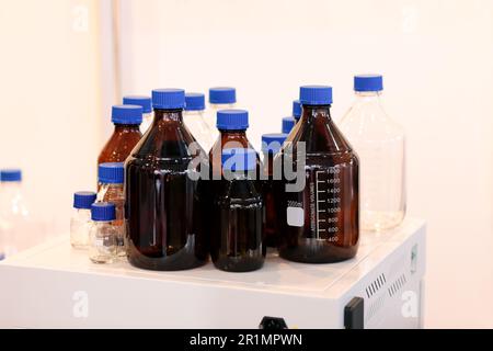 Empty glass reagent bottles in chemical laboratory. Selective focus. Stock Photo