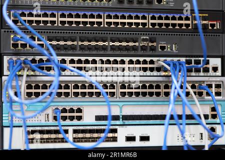 Racks with network equipment and patch cord cables. Selective focus. Stock Photo