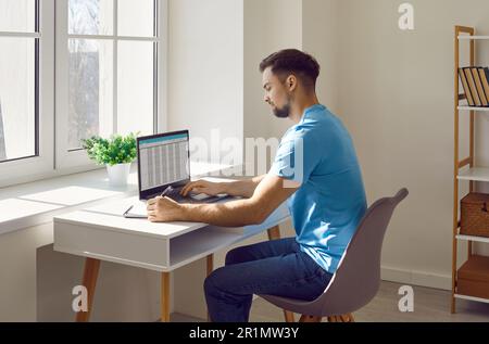 Businessman working with laptop and documents on his desk in office Stock Photo