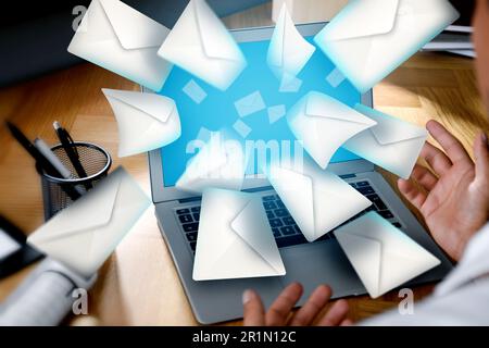 Email spam. Man with laptop and many letters, closeup Stock Photo