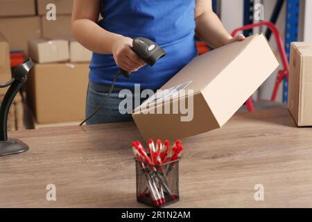 Post office worker with scanner reading parcel barcode at counter Stock ...