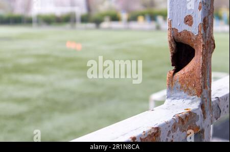 Bullet hole in the pipe. War in Ukraine. A hole from a shell fragment. Consequences of the war. Holes from shots on a metal pipe Stock Photo