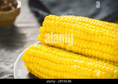 Delicious corn on the cob with melted butter. Close up with copy space. Stock Photo