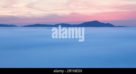 Dramatic clouds with mountain silhouette in dawn, Slovakia. Stock Photo