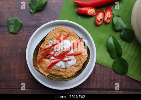 Steamed fish curry in banana leaf cups  - Famous Thai food called Hor Mok or fish Amok at top view Stock Photo