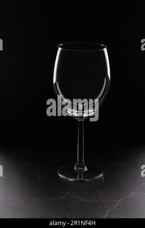 photo one empty glass on a dark background on the table Stock Photo