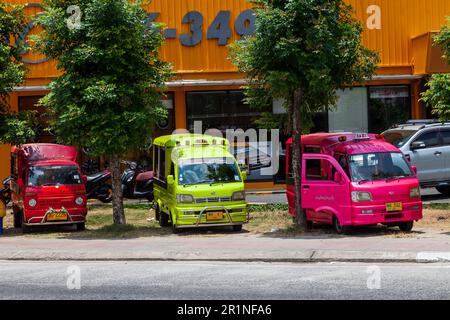 Thailand, Patong - 03.27.23: small Japanese trucks converted into taxis for tourists called tuk tuk in Thailand on the island of Phuket. Multi-colored Stock Photo