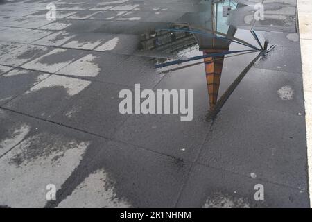 Naples, Italy. 13th May, 2023. The narrow pyramid dome designed by Atelier Mendini for Line 1 of the Naples underground reflected in the rain water. Line 1 is also called Art Stations where various Italian and international artists are present with works of art created specifically for the site or previously produced. Credit: Independent Photo Agency/Alamy Live News Stock Photo