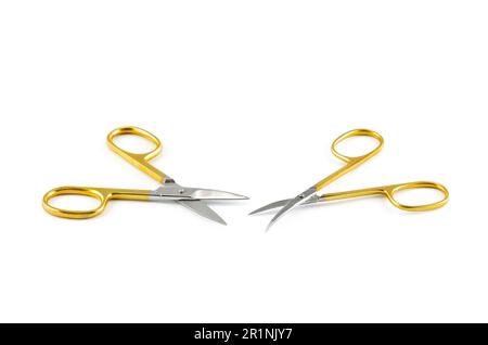 Gold silver metal nail scissors. Small metal manicure scissors isolated on white background. Stock Photo