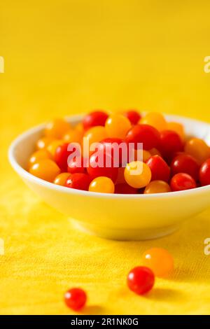 fresh red and yellow tomatoes cherry in a bowl Stock Photo
