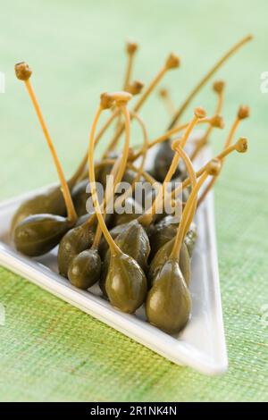 few marinated capers in a small white plate Stock Photo