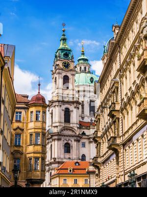 Historic architecture of downtown Prague, Czech Republic. Mostecka Street with St Nicholas Bell Tower Stock Photo