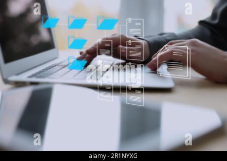 Electronic document management. Woman working on laptop at table, closeup Stock Photo