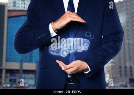 Man holding digital image of modern car outdoors, closeup Stock Photo