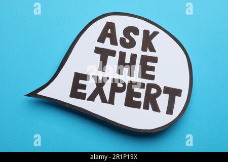 Speech bubble sticker with phrase Ask The Expert on light blue background Stock Photo