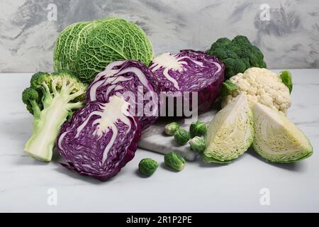 Many different types of cabbage on white marble table Stock Photo