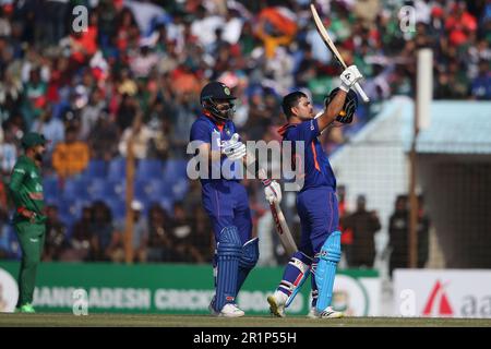 Indian batter Ishan Kishan celebrates his hundred runs along Virat kohli during the Bangladesh-India third One Day International (ODI) match at Zahur Stock Photo