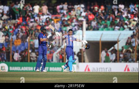 Indian batter Ishan Kishan celebrates his hundred runs along Virat kohli during the Bangladesh-India third One Day International (ODI) match at Zahur Stock Photo